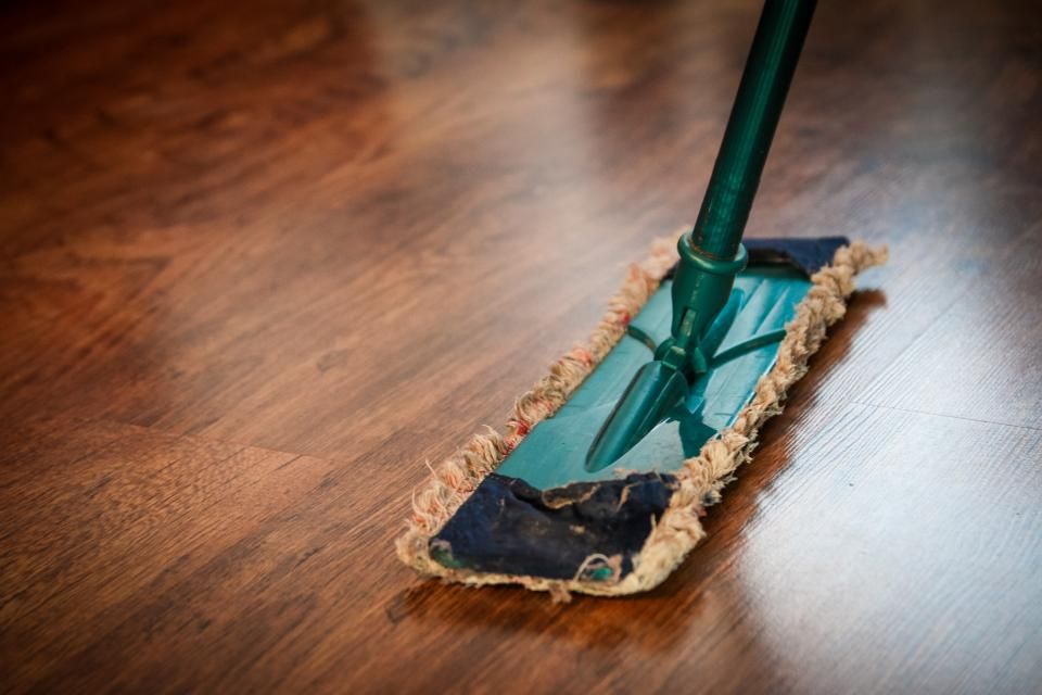A flat mop on a polished wood floor