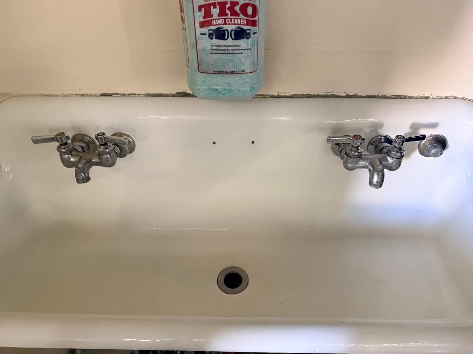 The same utility sink, white and free of stains